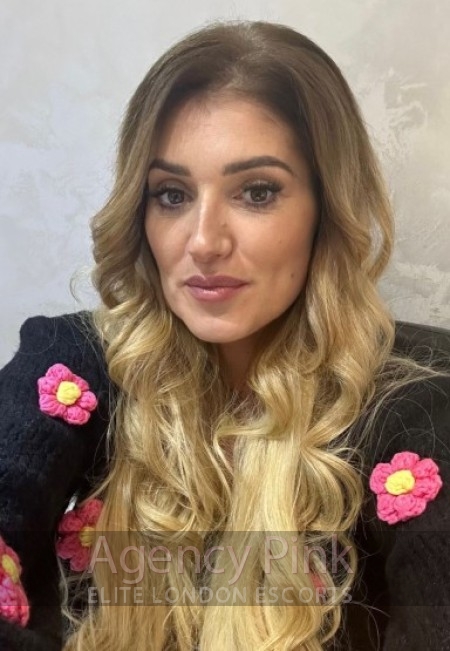 A stylish escort posing for a selfie for her profile.