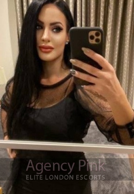 Saskia escort selfie photo in a black fur coat