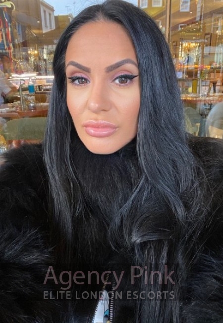 Saskia escort selfie photo in a black fur coat